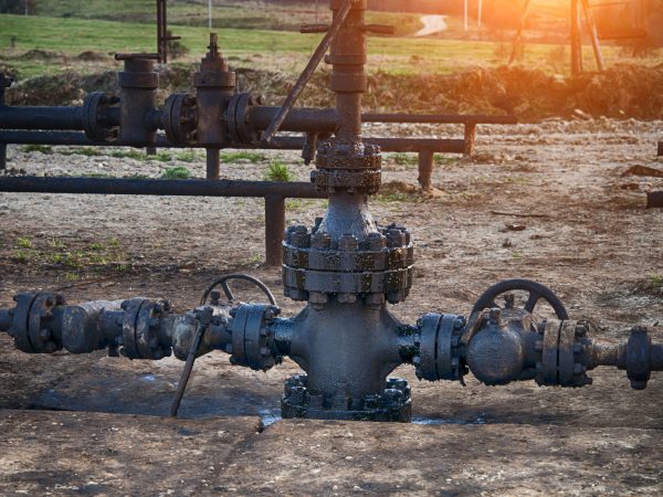 Spilled crude oil around oil field. Oil and Gas Industry